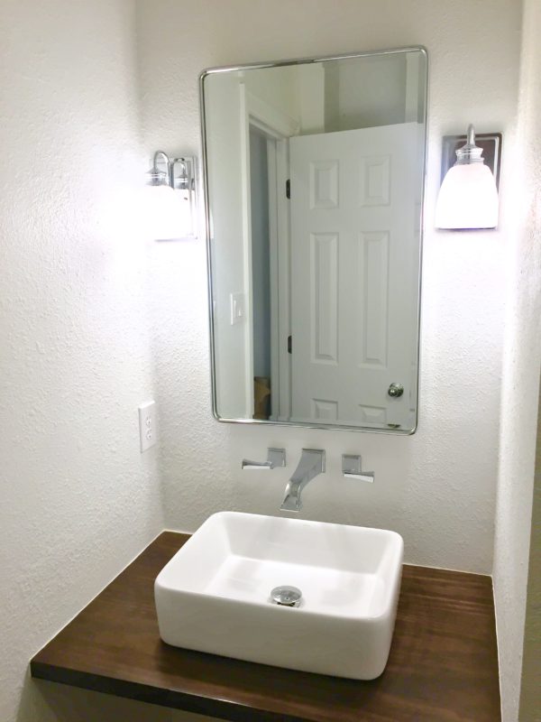 See our Guest Bathroom Remodel progress! We're building a disability-friendly guest bathroom including this $20 floating wood vanity with vessel sink!