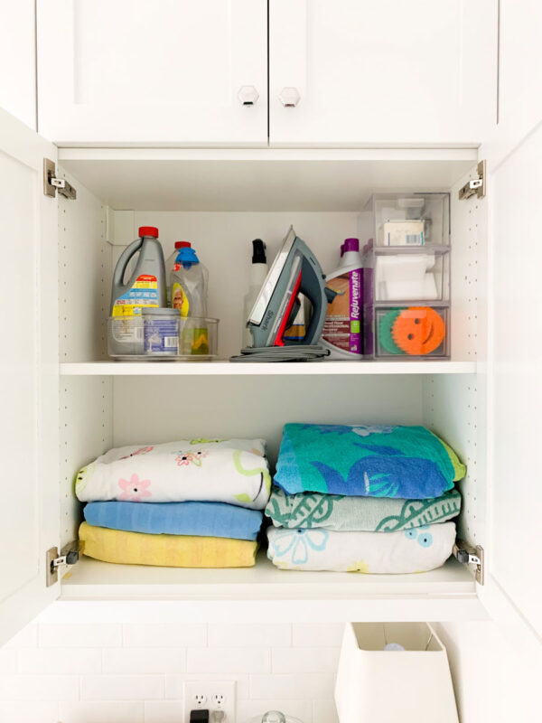 Pool Towel Storage and extra cleaning supplies in our laundry room cabinets