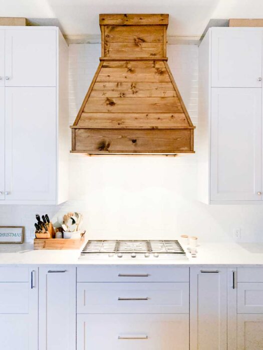 See how I built this DIY Farmhouse Vent Hood Cover for less than $200! Vent Hood | Vent Hood Ideas | Farmhouse | Joanna Gaines | Fixer Upper | DIY | Modern Farmhouse | Kitchen Remodel | Kitchen Renovation | White Kitchen | Rustic Vent Hood | Farmhouse Vent Hood | Farmhouse Vent Hood Ideas | Farmhouse Vent Hood DIY | Vent Hood Over Stove | Wooden Vent Hood