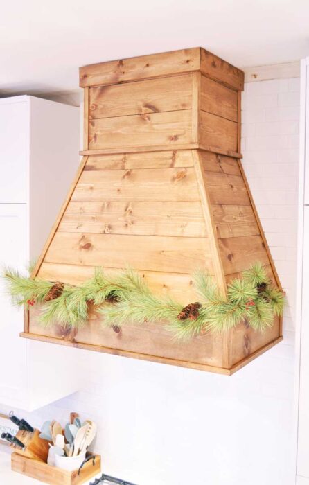 See how I built this DIY Farmhouse Vent Hood Cover for less than $200! Vent Hood | Vent Hood Ideas | Farmhouse | Joanna Gaines | Fixer Upper | DIY | Modern Farmhouse | Kitchen Remodel | Kitchen Renovation | White Kitchen | Rustic Vent Hood | Farmhouse Vent Hood | Farmhouse Vent Hood Ideas | Farmhouse Vent Hood DIY | Vent Hood Over Stove | Wooden Vent Hood