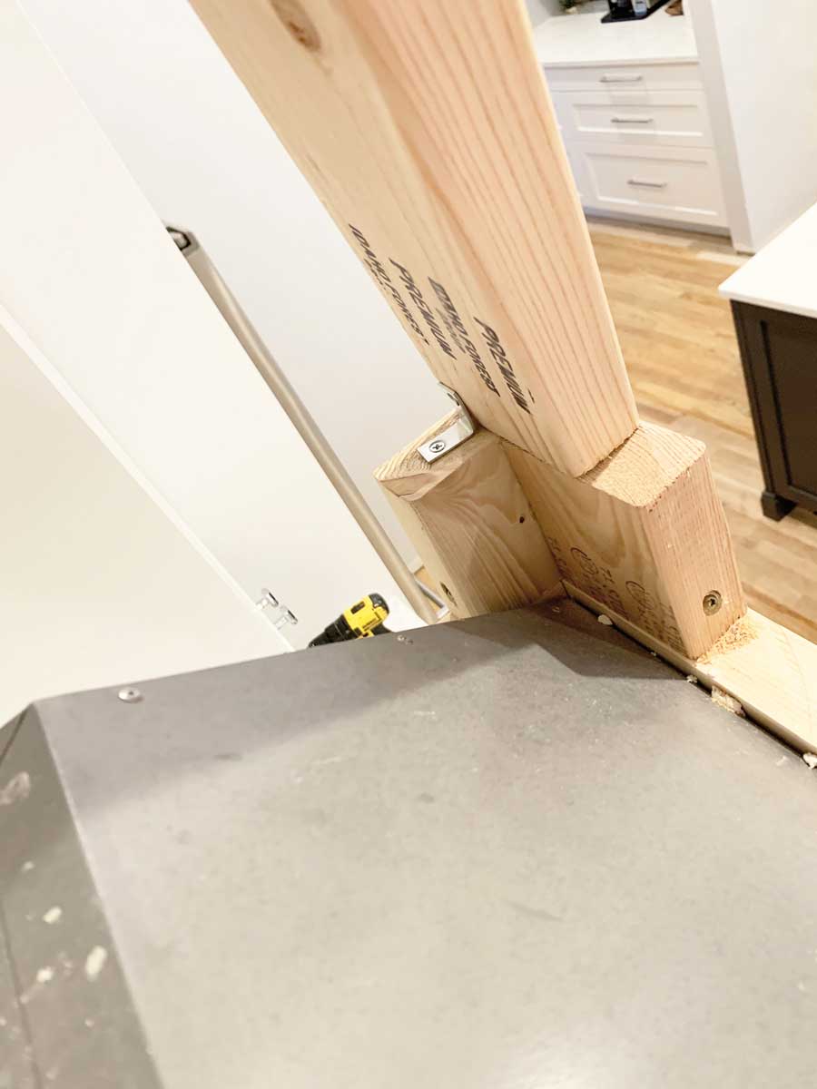 See how I built this DIY Farmhouse Vent Hood Cover for less than $200!
