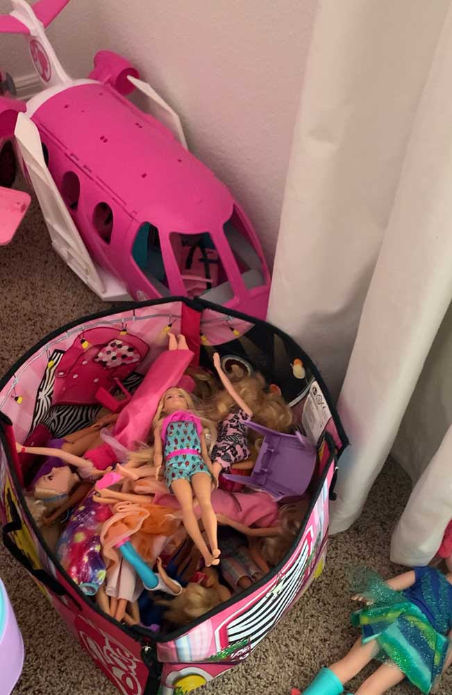 This bin stuffed with dolls was how we organized our Barbie Collection before we organized them in Anthropolgie-Inspired DIY Magazine Racks. 
